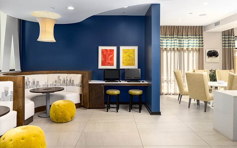 a lobby with a blue wall and seating