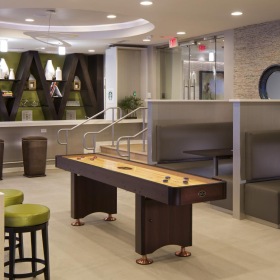 a room with a bar and chairs