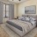 a bedroom with a bed and a fan